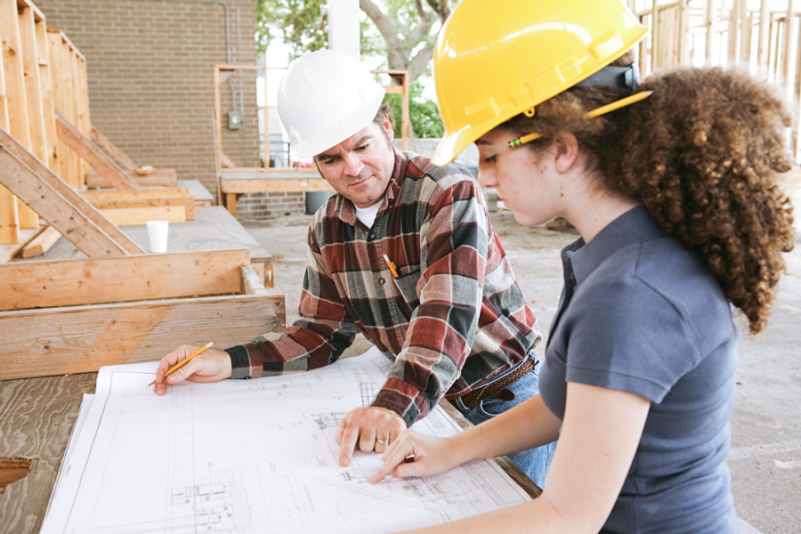 Vocational education student learning to read construction blueprints.