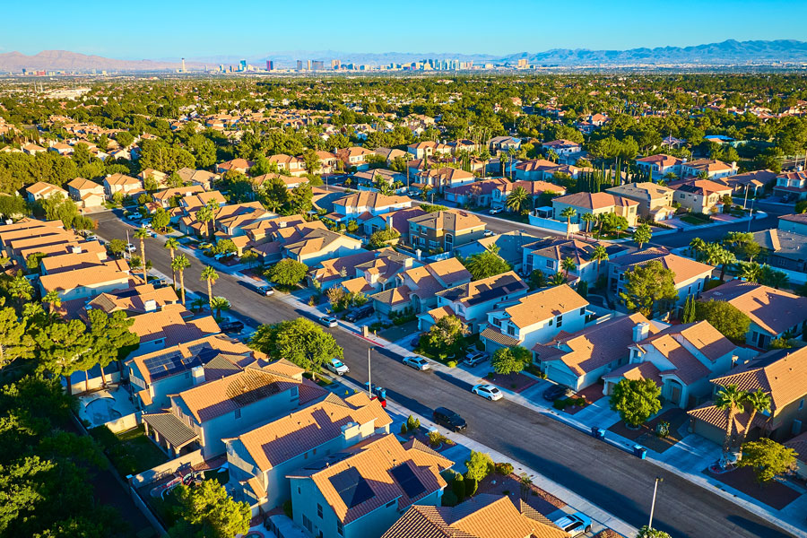 Aerial Suburban Las Vegas with Desert and Skyline at Sunset